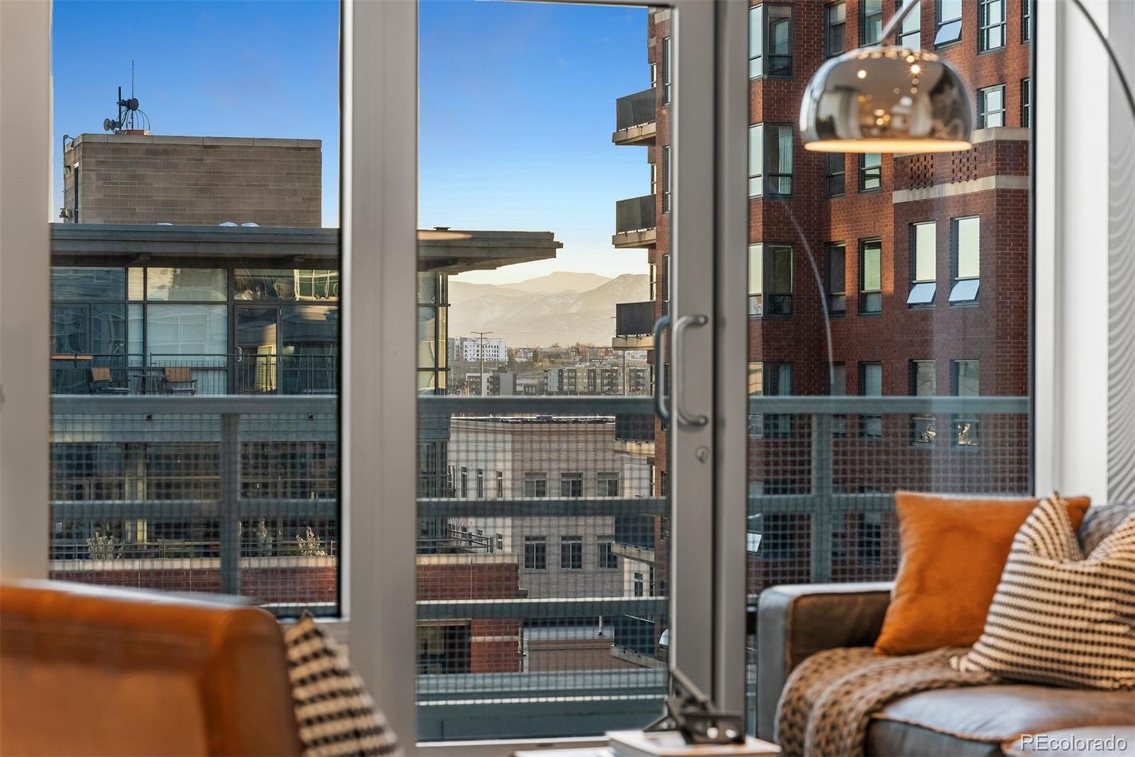 1610 Little Raven Street, Unit PH6 Denver, CO 80202 - Photo 23 of 41 a view of a balcony with couches and wooden floor