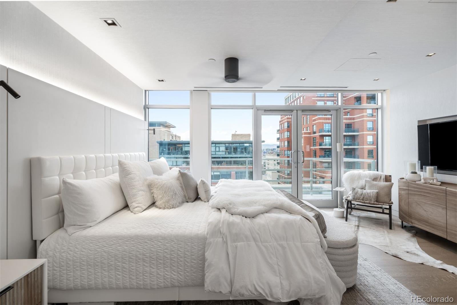 1610 Little Raven Street, Unit PH6 Denver, CO 80202 - Photo 25 of 41 a bedroom with a large bed and a flat tv screen