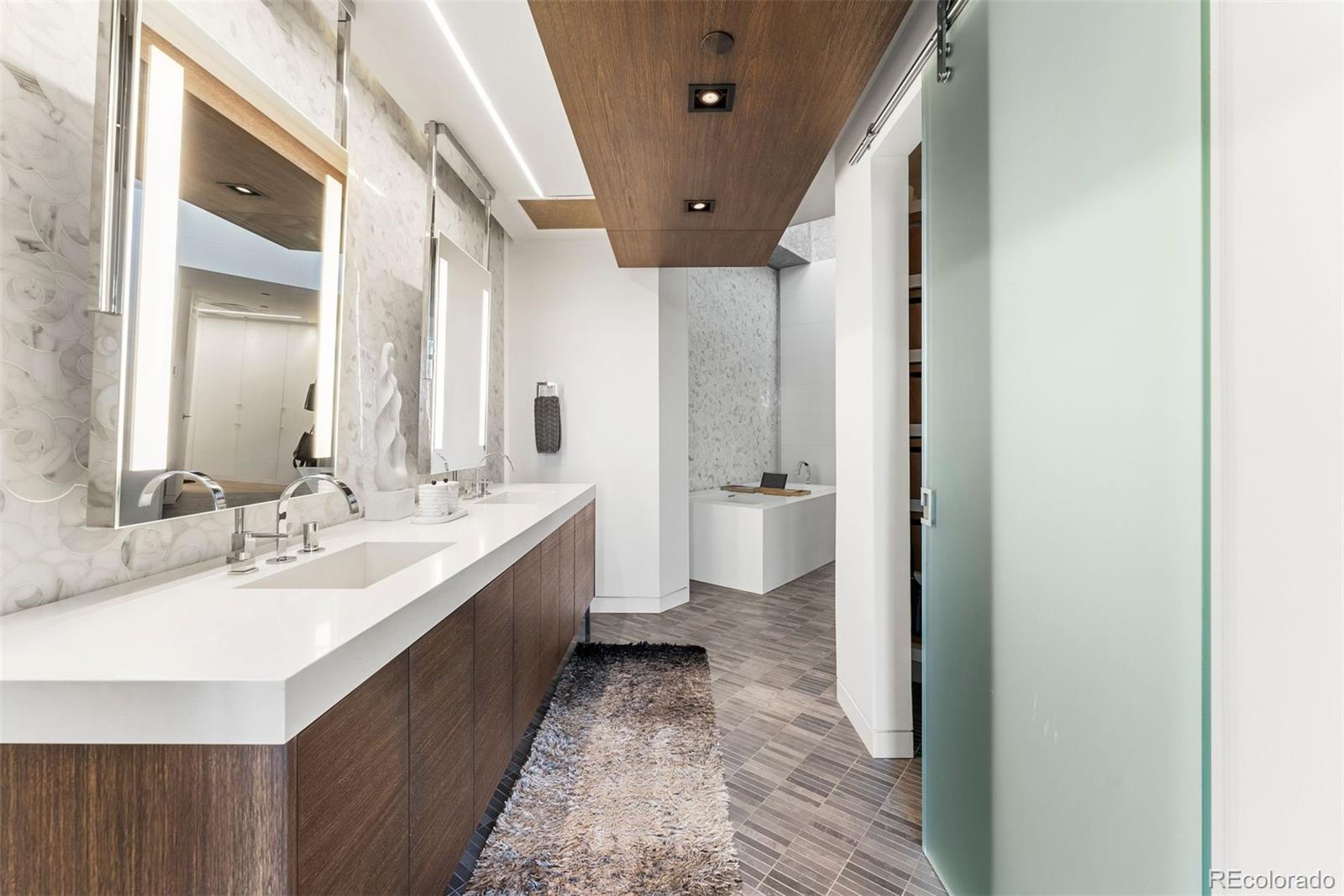 1610 Little Raven Street, Unit PH6 Denver, CO 80202 - Photo 26 of 41 a spacious bathroom with a double vanity sink and a mirror