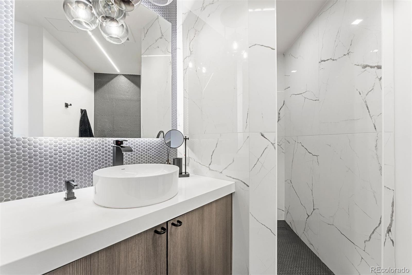 1610 Little Raven Street, Unit PH6 Denver, CO 80202 - Photo 35 of 41 a bathroom with a sink and a mirror