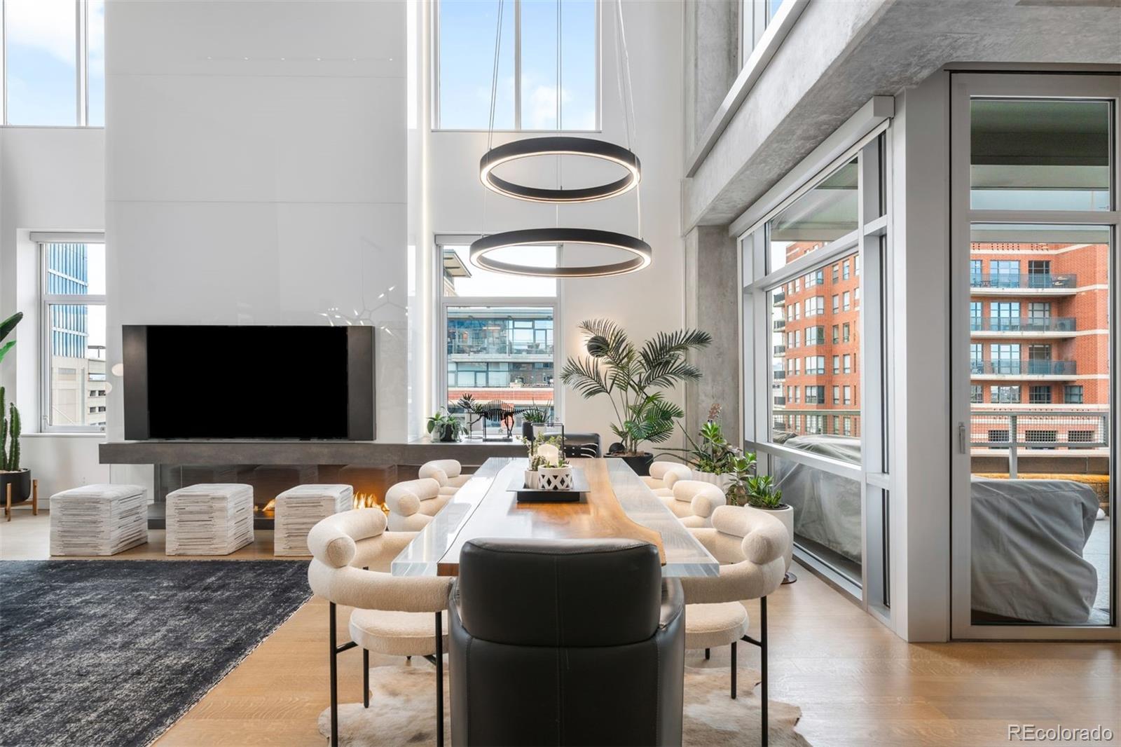 1610 Little Raven Street, Unit PH6 Denver, CO 80202 - Photo 4 of 41 a living room with fireplace furniture and a flat screen tv