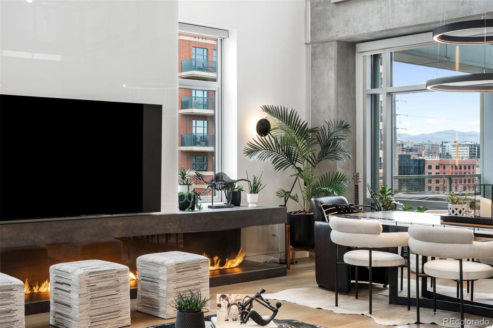 1610 Little Raven Street, Unit PH6 Denver, CO 80202 - Photo 5 of 41 a living room with furniture a rug and a floor to ceiling window