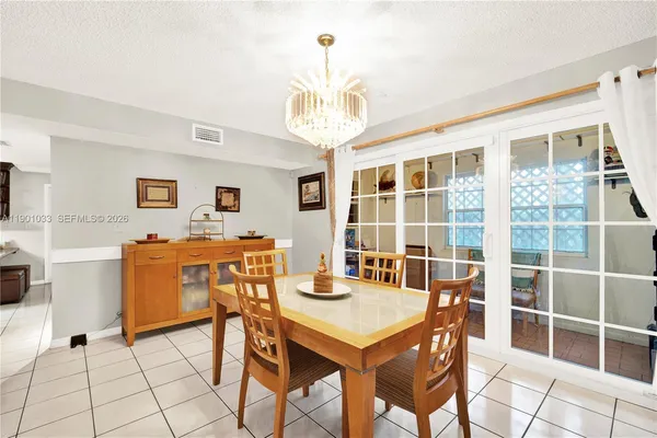 a view of a dining room with furniture and a chandelier