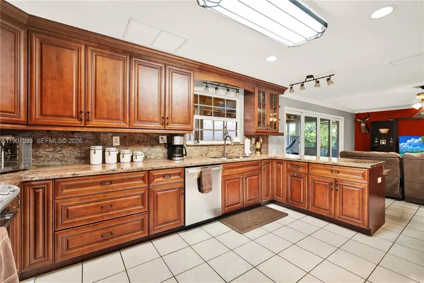 a kitchen with stainless steel appliances granite countertop a sink and cabinets
