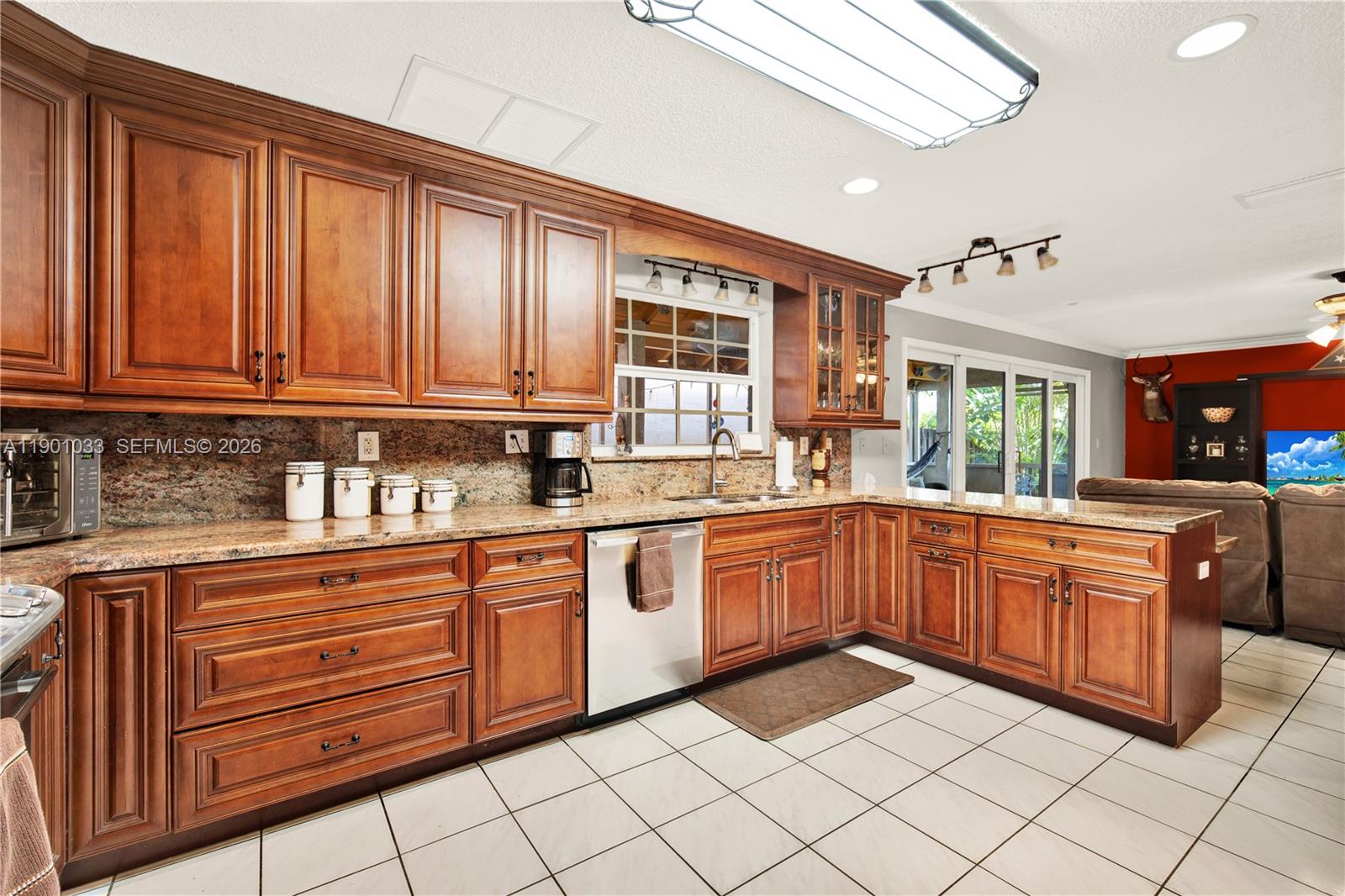 10825 Southwest 91st Lane Miami, FL 33176 - Photo 14 of 47 a kitchen with stainless steel appliances granite countertop a sink and cabinets