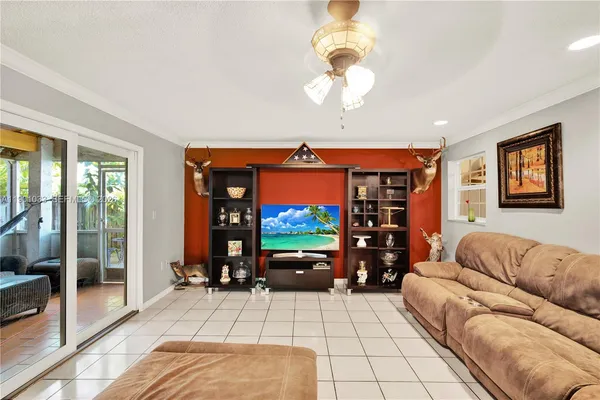 a living room with furniture a window and flat screen tv
