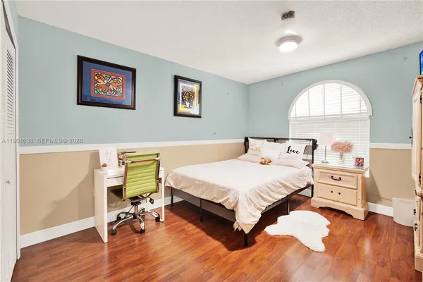 a bedroom with a bed and a dresser