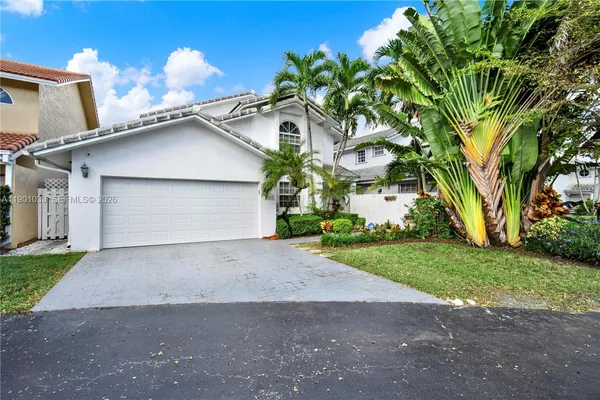 a view of a house with a yard and garage