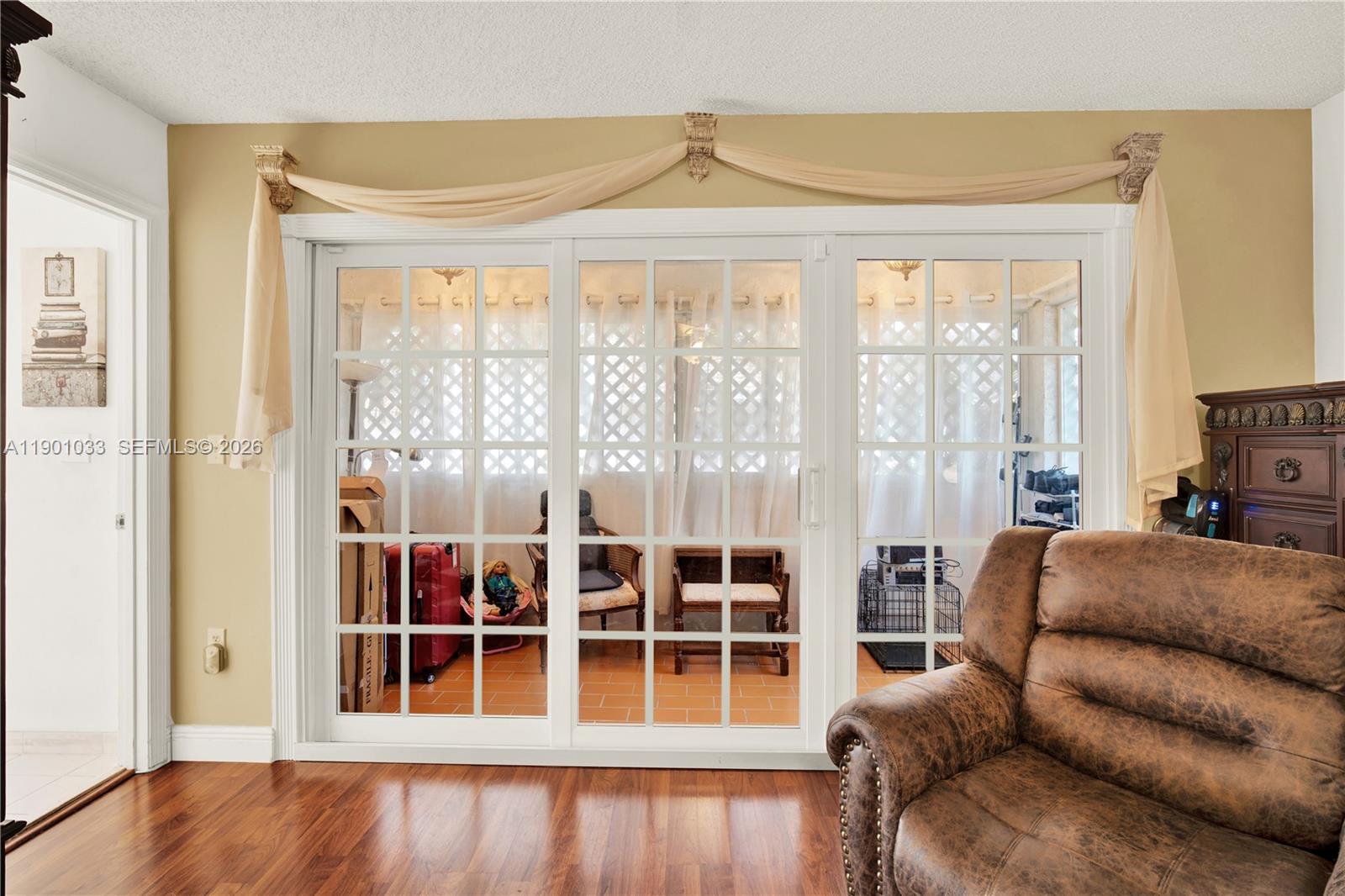 10825 Southwest 91st Lane Miami, FL 33176 - Photo 28 of 47 a living room with furniture windows and a wooden floor