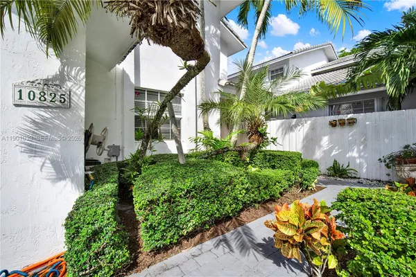 an aerial view of a house with a yard and potted plants
