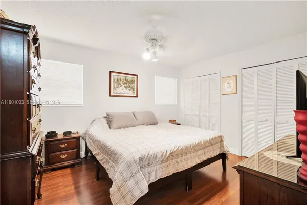 a bedroom with a bed and a flat screen tv