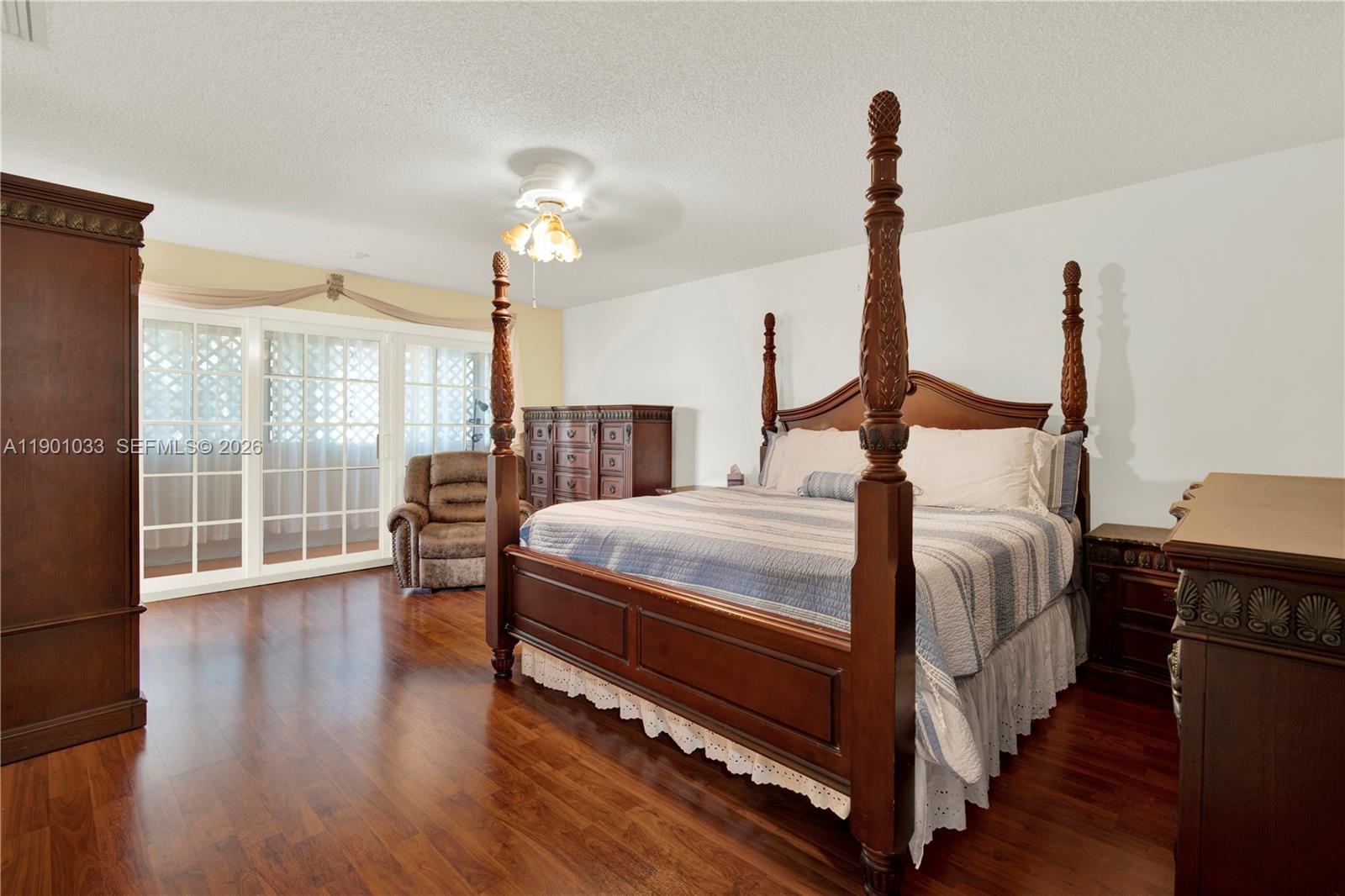 10825 Southwest 91st Lane Miami, FL 33176 - Photo 33 of 52 a bedroom with a bed and wooden floor