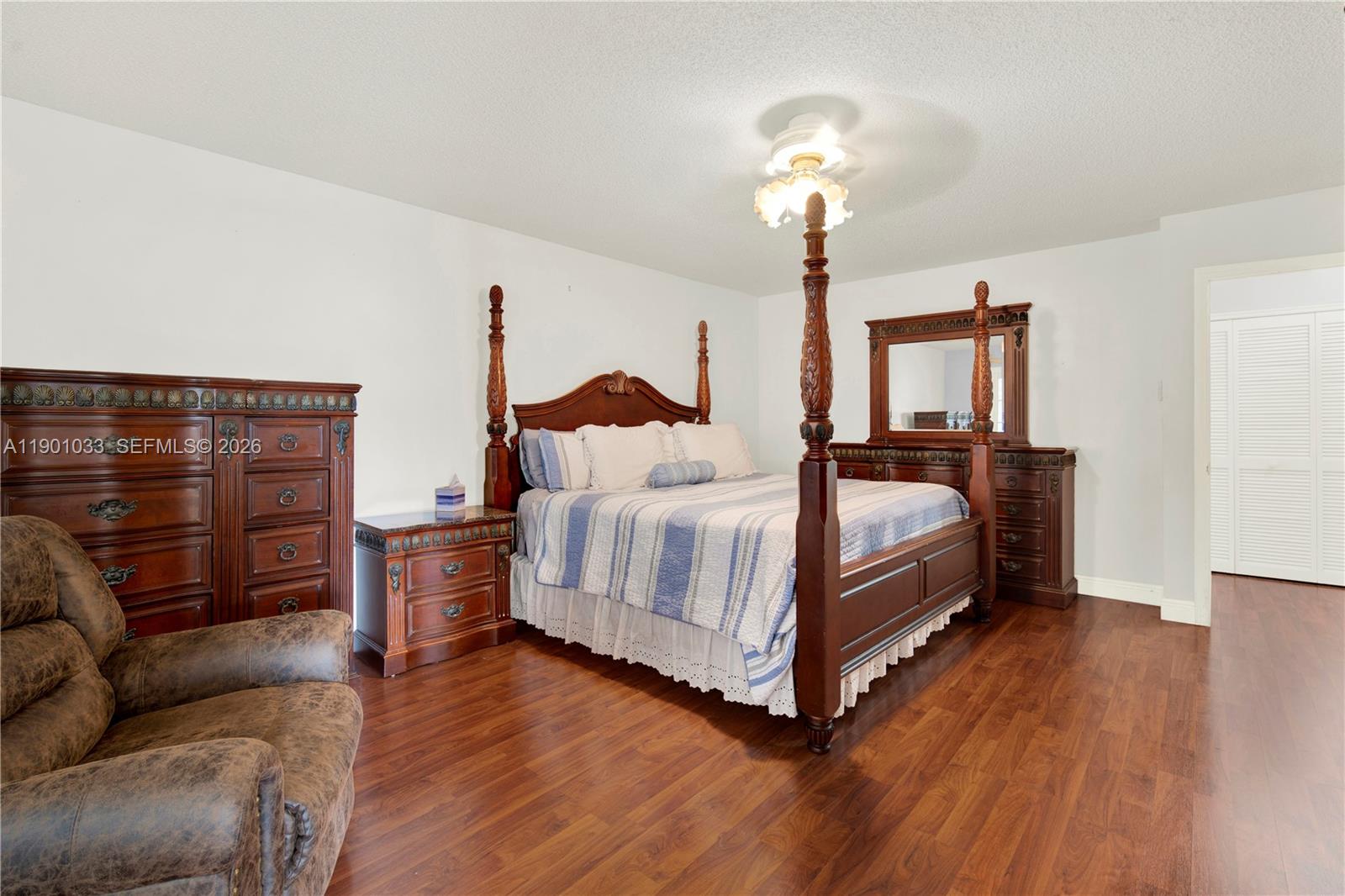 10825 Southwest 91st Lane Miami, FL 33176 - Photo 34 of 52 a bedroom with a bed lamp closet and three large window