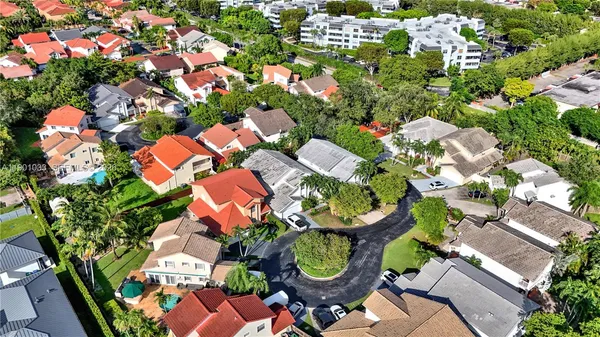 an aerial view of a house with swimming pool and outdoor seating