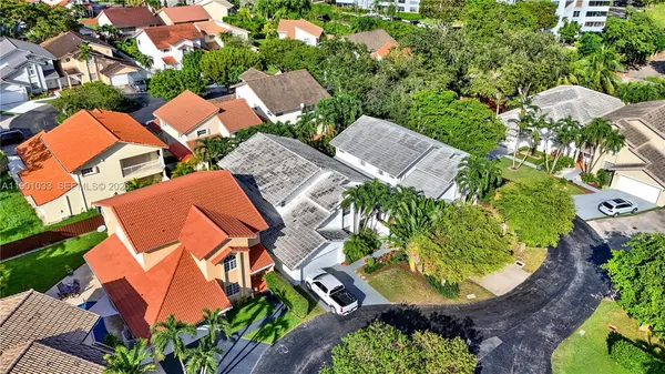 an aerial view of a house with swimming pool and outdoor space