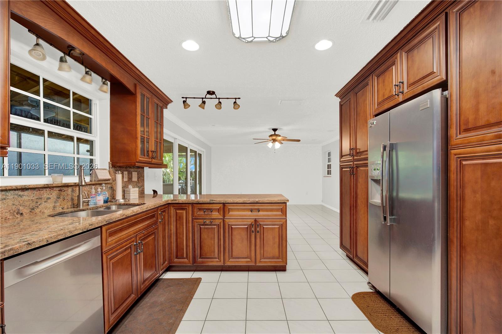 10825 Southwest 91st Lane Miami, FL 33176 - Photo 9 of 52 a kitchen with stainless steel appliances granite countertop a refrigerator and a sink