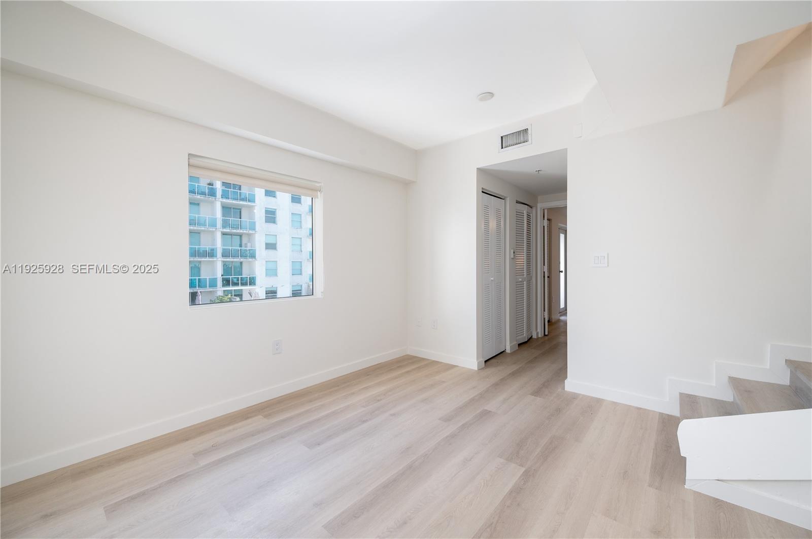 1712 Southwest 2nd Avenue, Unit 802 Miami, FL 33129 - Photo 16 of 30 an empty room with wooden floor and windows