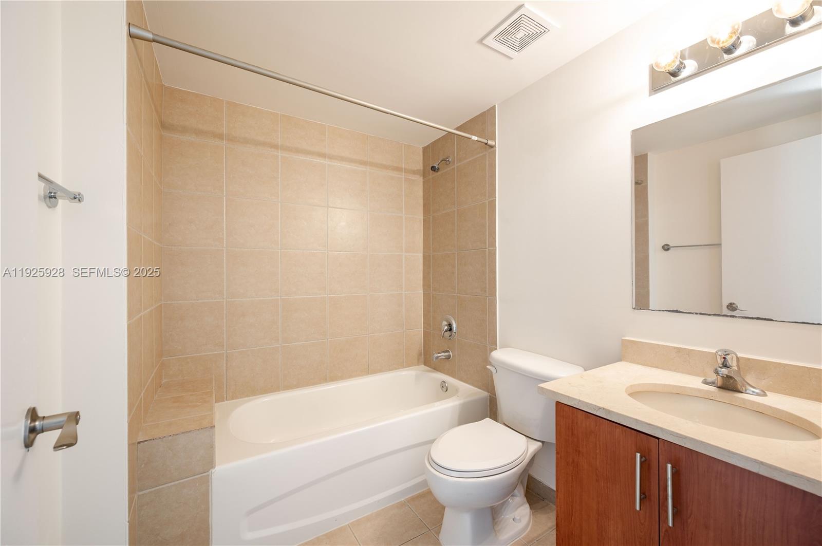 1712 Southwest 2nd Avenue, Unit 802 Miami, FL 33129 - Photo 20 of 30 a bathroom with a sink a toilet and shower