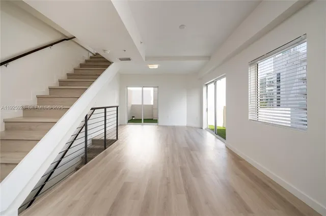 a view of a kitchen with a table and chairs