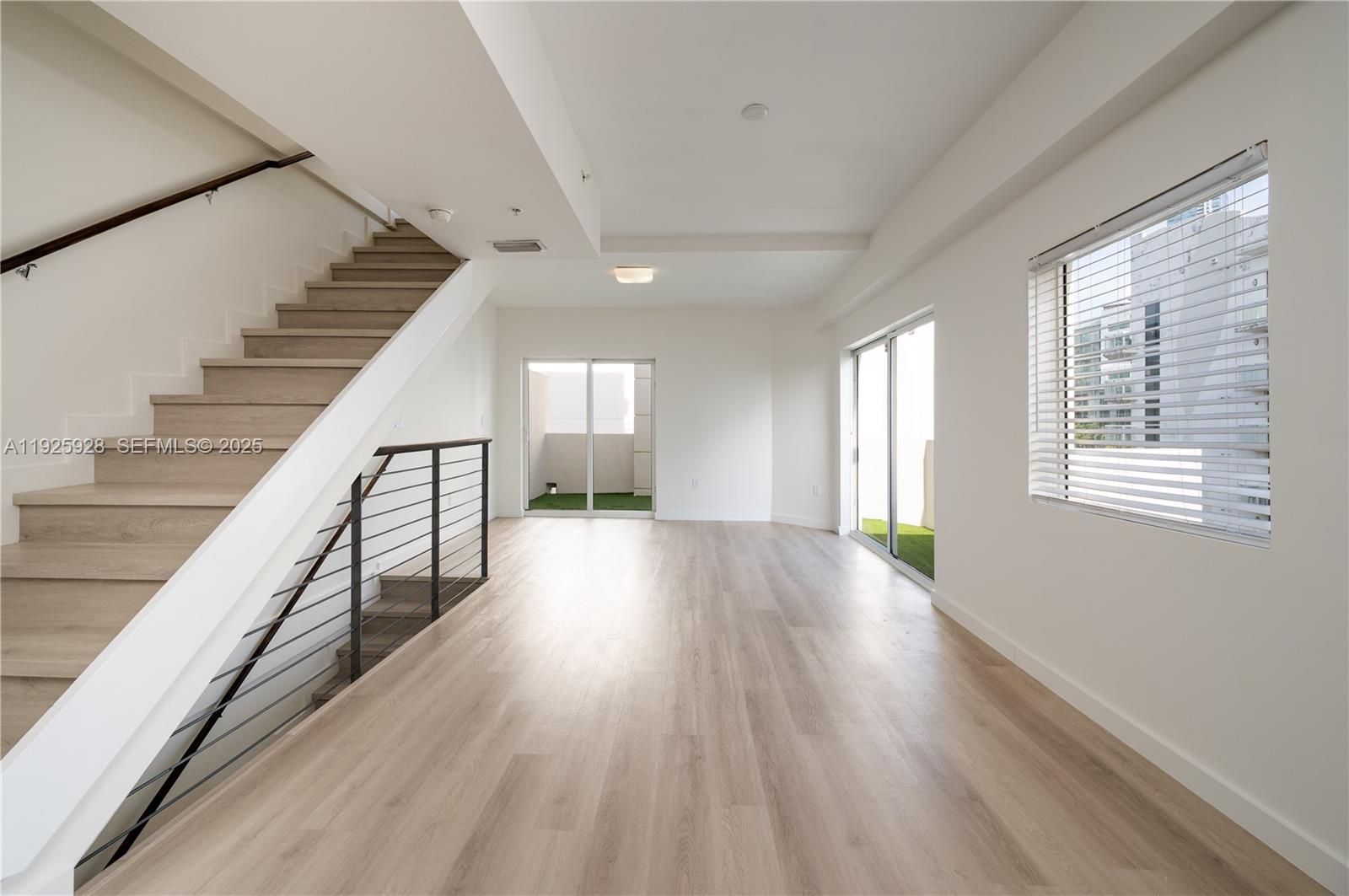 1712 Southwest 2nd Avenue, Unit 802 Miami, FL 33129 - Photo 23 of 30 a view of an empty room with wooden floor and a window