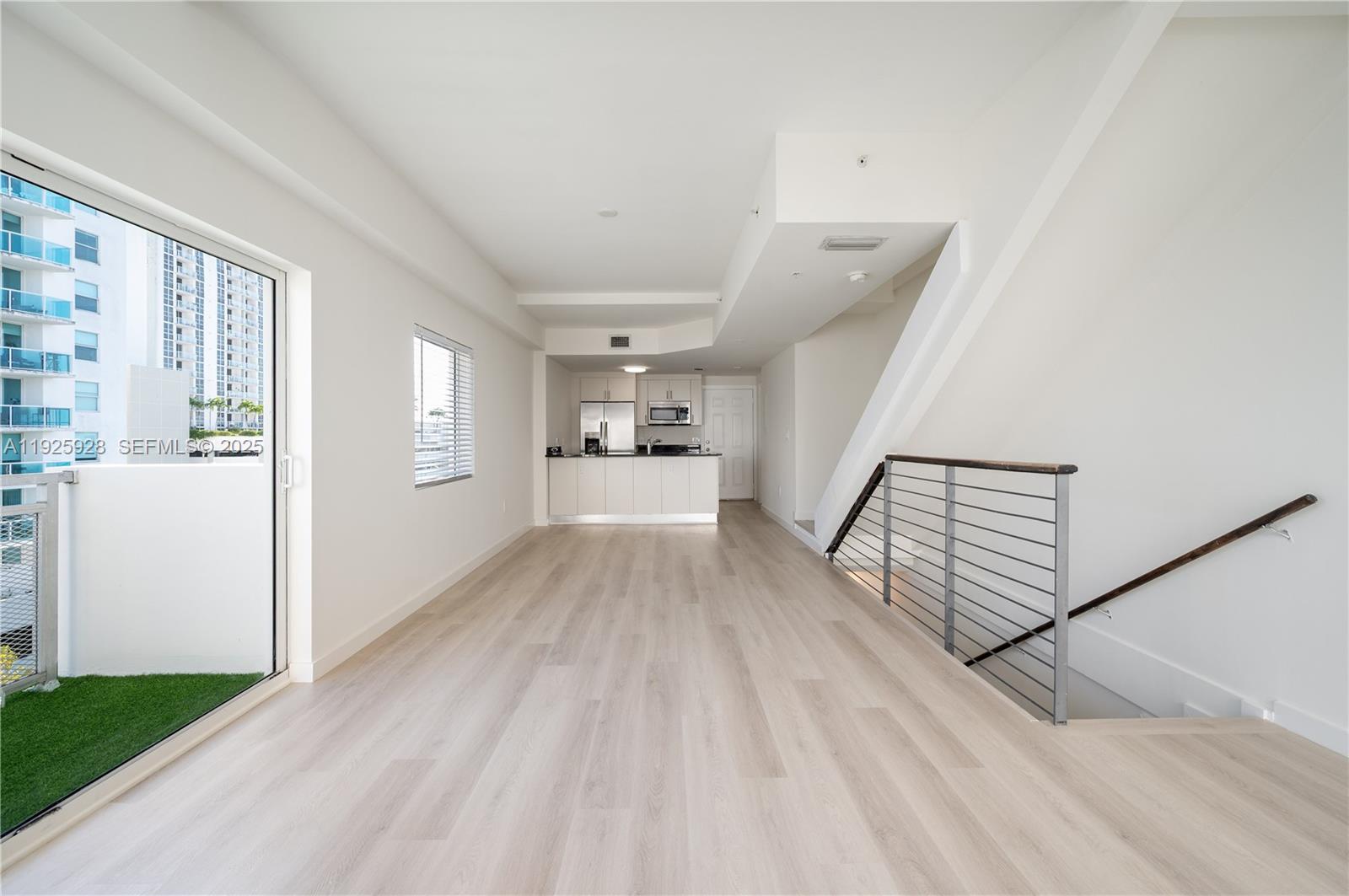 1712 Southwest 2nd Avenue, Unit 802 Miami, FL 33129 - Photo 7 of 30 a view of a living room hardwood floor and a kitchen
