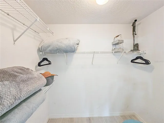 a view of a bedroom with wooden floor and staircase