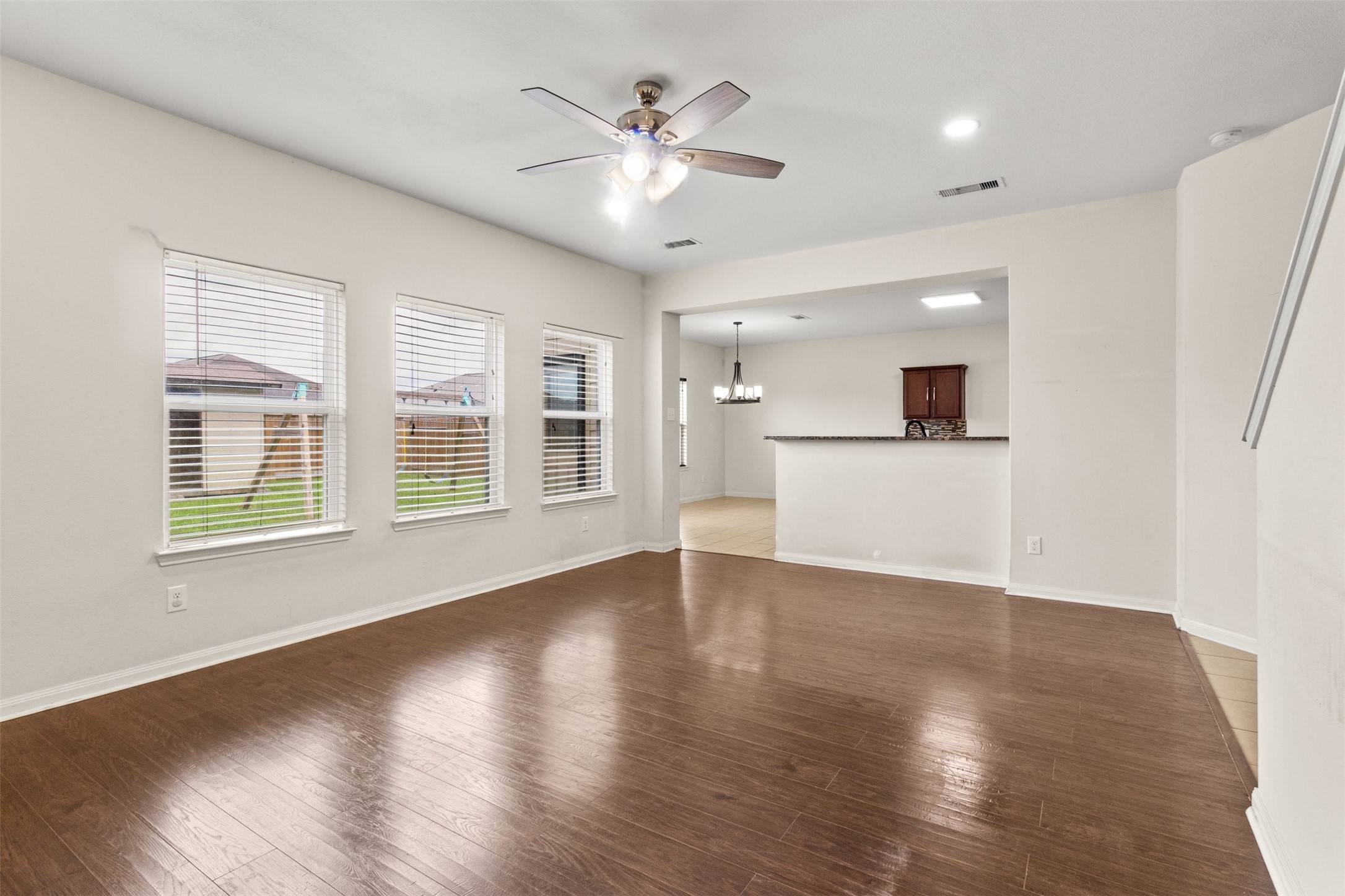 9426 Grand Spark Drive Rosharon, TX 77583 - Photo 5 of 31 Large windows bring the outdoors in while providing views of the backyard. The open-concept design keeps everyone connected whether relaxing in the living room or preparing meals nearby.