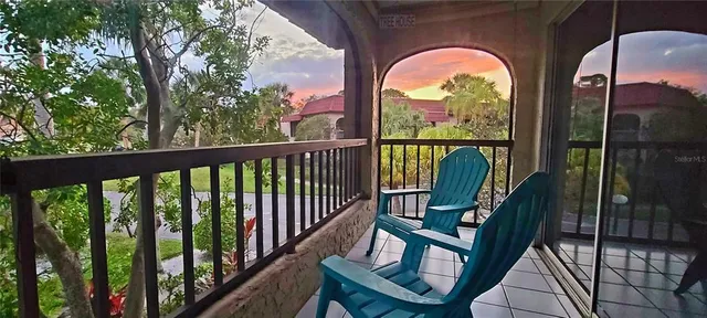a view of a chairs and table in the balcony