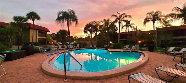 an aerial view of ocean and residential houses with outdoor space