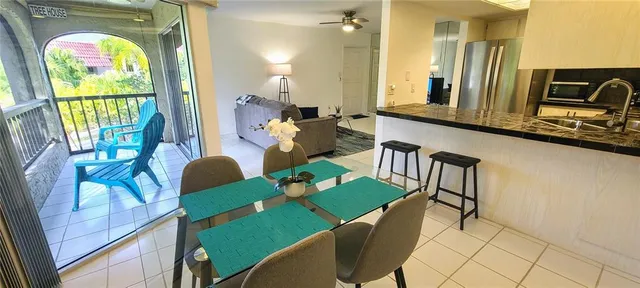 a view of a dining room with furniture a livingroom and chandelier