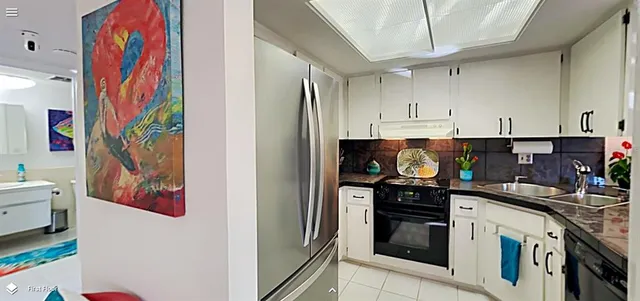 a kitchen with stainless steel appliances and cabinets