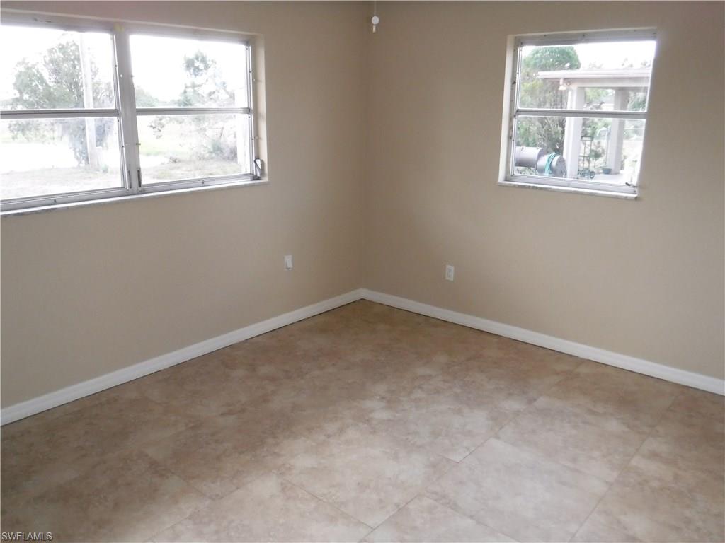 106 Oleander Road Lehigh Acres, FL 33936 - Photo 11 of 17 an empty room with a window
