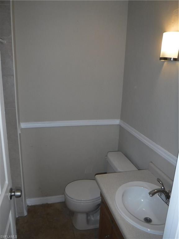 106 Oleander Road Lehigh Acres, FL 33936 - Photo 13 of 17 a bathroom with a toilet and a sink