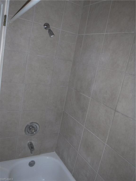106 Oleander Road Lehigh Acres, FL 33936 - Photo 14 of 17 a bathroom with a bathtub