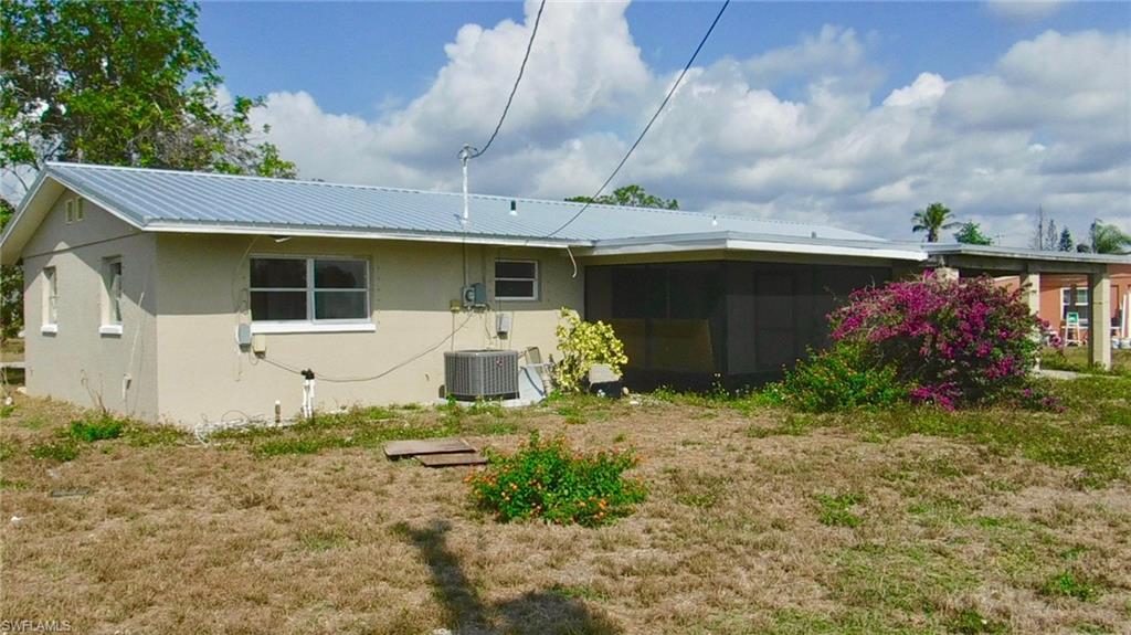 106 Oleander Road Lehigh Acres, FL 33936 - Photo 17 of 17 a front view of a house with garden