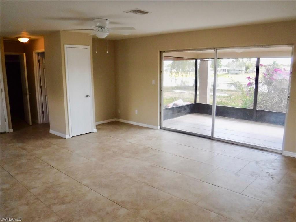 106 Oleander Road Lehigh Acres, FL 33936 - Photo 3 of 17 a view of an empty room and window