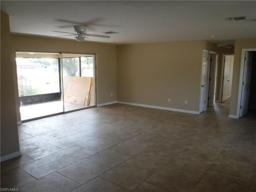 106 Oleander Road Lehigh Acres, FL 33936 - Photo 5 of 17 a view of an empty room with a window