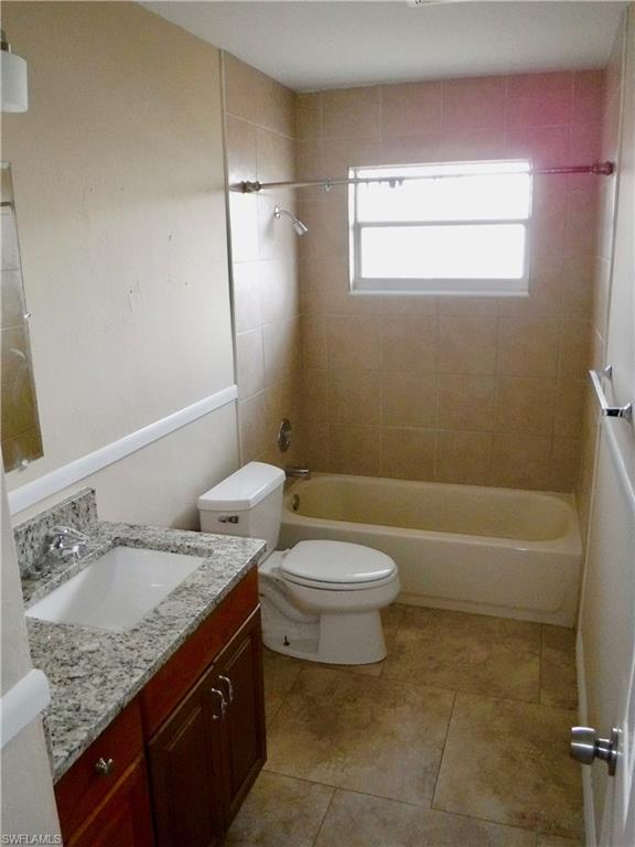106 Oleander Road Lehigh Acres, FL 33936 - Photo 8 of 17 a bathroom with a granite countertop sink toilet and shower