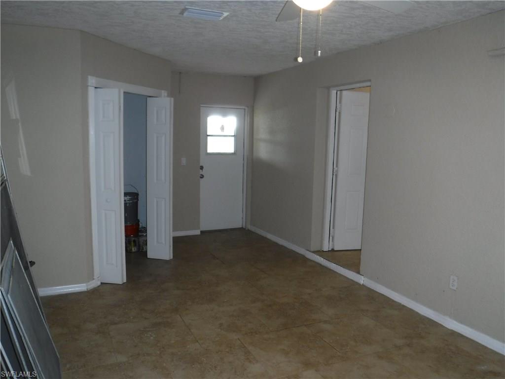 106 Oleander Road Lehigh Acres, FL 33936 - Photo 9 of 17 an empty room with windows