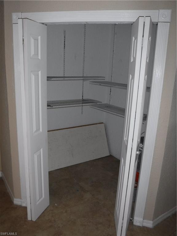 106 Oleander Road Lehigh Acres, FL 33936 - Photo 10 of 17 a view of walk in closet with empty racks