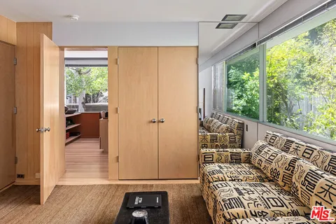 a view of a hallway with wooden floor and windows