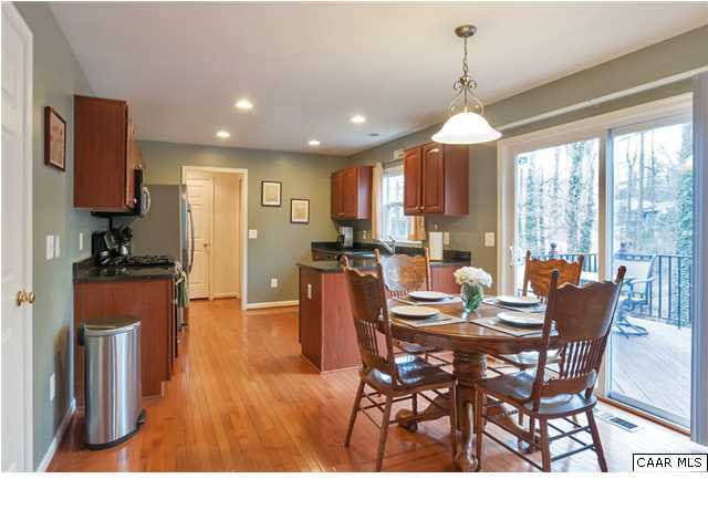 602 Rainier Road Charlottesville, VA 22903 - Photo 5 of 18 a dining room with furniture a chandelier and wooden floor