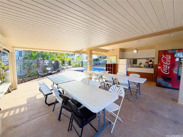a dining room with furniture and a floor to ceiling window