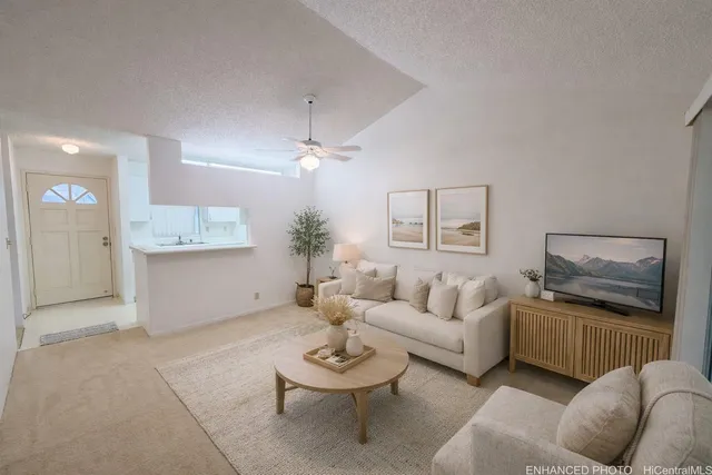 a living room with furniture and a chandelier