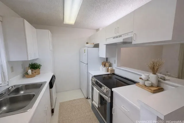 a kitchen that has a sink and a stove in it