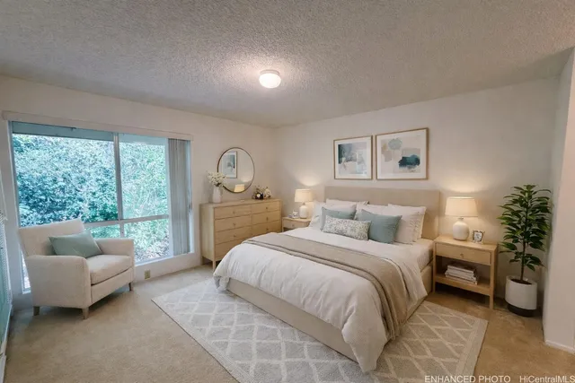 a spacious bedroom with a bed and a couch