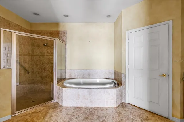 a bathroom with a tub and a shower