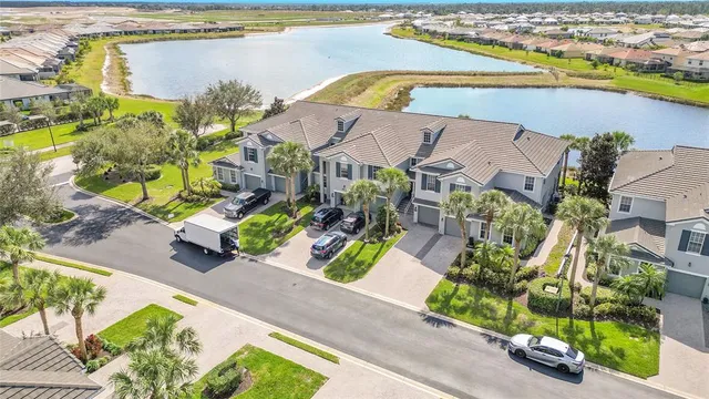 an aerial view of residential houses with outdoor space and swimming pool