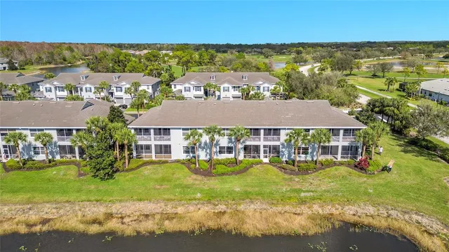 an aerial view of residential houses with outdoor space and swimming pool