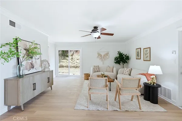 a living room with furniture a chandelier and a window